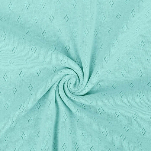 Light turquoise Pointelle Jersey - Peppermint from Once Upon A Fabric with diamond-shaped perforations. The pointelle cotton jersey fabric appears lightweight, suggesting it may be perfect for baby clothes or accessories.