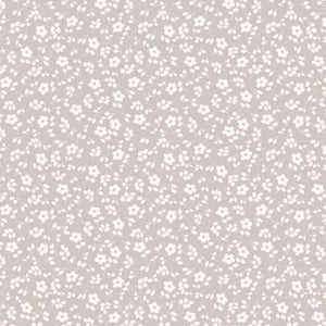 A seamless floral pattern with small, white flowers and leaves on a light beige background. The flowers are evenly distributed, creating a continuous and repetitive design across the surface of this Oeko-Tex 100 certified Cotton Jersey Fabric - Millefleur Taupe by Once Upon A Fabric, ideal for dressmaking fabric.