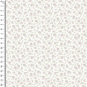 A fabric sample featuring a small floral print with grey flowers and green leaves on a white background. Made from Cotton Jersey Fabric - Millefleur Off White by Once Upon A Fabric, it’s ideal for dressmaking. A ruler along the left side shows measurements in inches from 1 to 18, indicating the scale of the print. Oeko-Tex 100 certified for quality.
