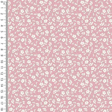 Load image into Gallery viewer, A pink dressmaking fabric with a white floral pattern. A ruler is placed along the left side of the Cotton Jersey Fabric - Millefleur Old Rose by Once Upon A Fabric, showing measurements from 1 to 18 inches. This Oeko-Tex 100 certified fabric ensures quality and safety in your projects.
