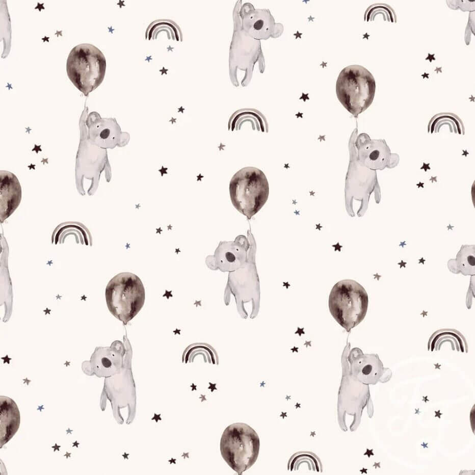 Patterned image featuring cute koalas holding balloons, surrounded by small stars and rainbows on a light beige background. The koalas, stars, and rainbows are sketched in a soft, pastel color palette. Designed for **Jersey Fabric - KOALAS BROWN by Family Fabrics**, ideal for baby clothes and Oeko-Tex 100 certified. 