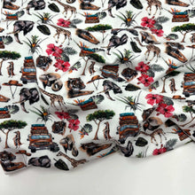 Load image into Gallery viewer, A digitally printed **Once Upon A Fabric LAST METER Cotton Jersey Fabric - Holiday** with a colorful design featuring jungle animals, trees, tropical flowers, and vintage vehicles. The detailed illustrations of elephants, giraffes, zebras, and tigers are highlighted against a white background. Plus, it’s Oeko-Tex 100 certified for added assurance.
