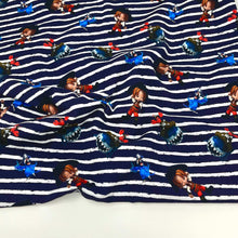 Load image into Gallery viewer, A Cotton Jersey Fabric - Pirate Navy with a navy blue and white striped pattern featuring cartoon characters. The characters include several wearing red outfits, blue outfits, and various other colors, spaced evenly across the fabric&#39;s surface. Ideal for baby clothes and Oeko-Tex 100 certified for safety by Once Upon A Fabric.
