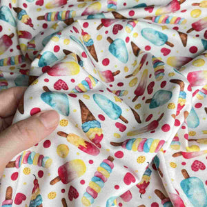 Colourful stretch fabric with illustrations of ice cream, cones, ice lollies, popsicles, set against a white background.