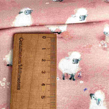 Load image into Gallery viewer, Baby fabric features a delightful pattern of small white sheep on a pink background, interspersed with tiny white flowers.
