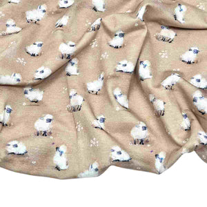 Baby fabric features a delightful pattern of small white sheep on a beige background, interspersed with tiny white flowers.